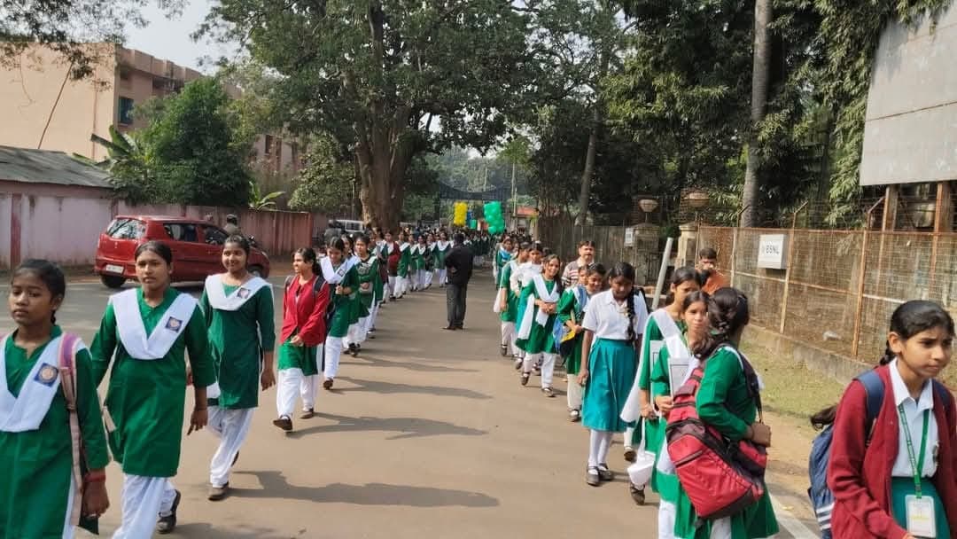 Girls in green uniforms marching on the street