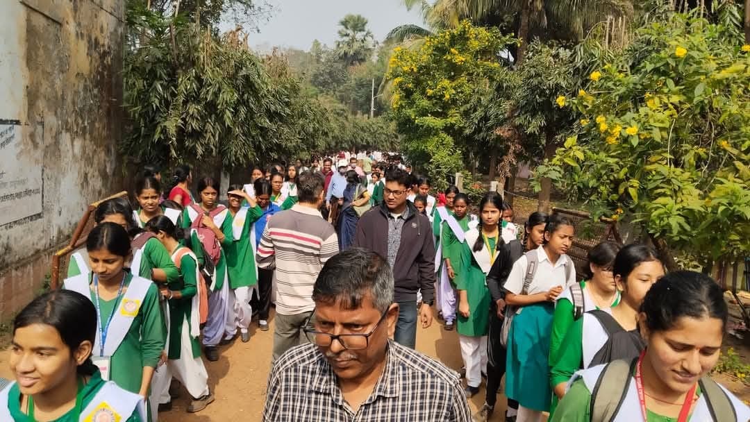 Students walking in green uniforms during the rally